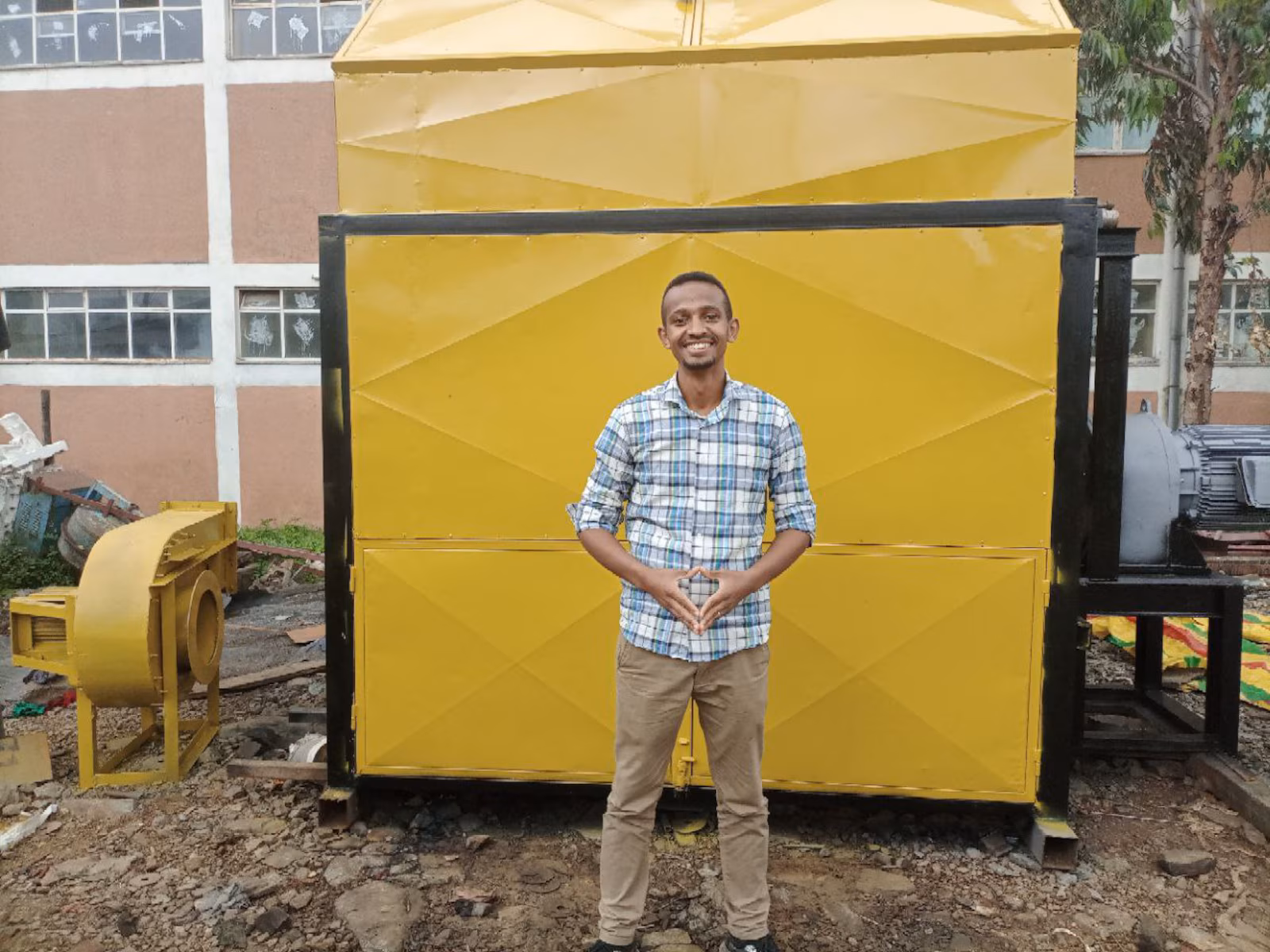 Green Bean farmer stood in front of machine