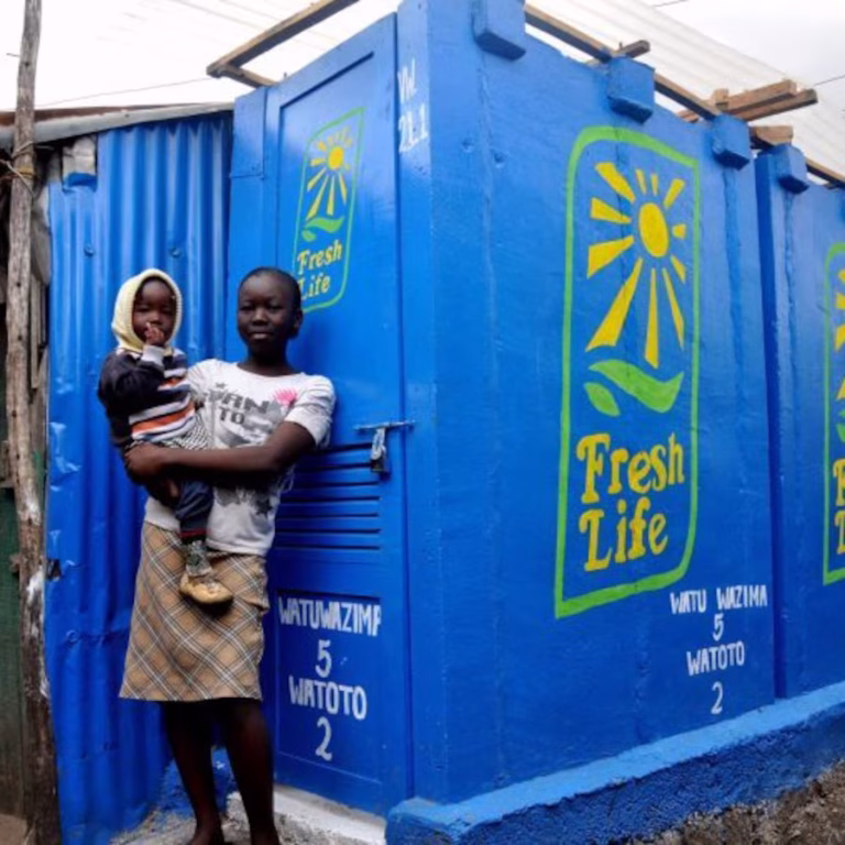 Mother and child outside FreshLife toilet