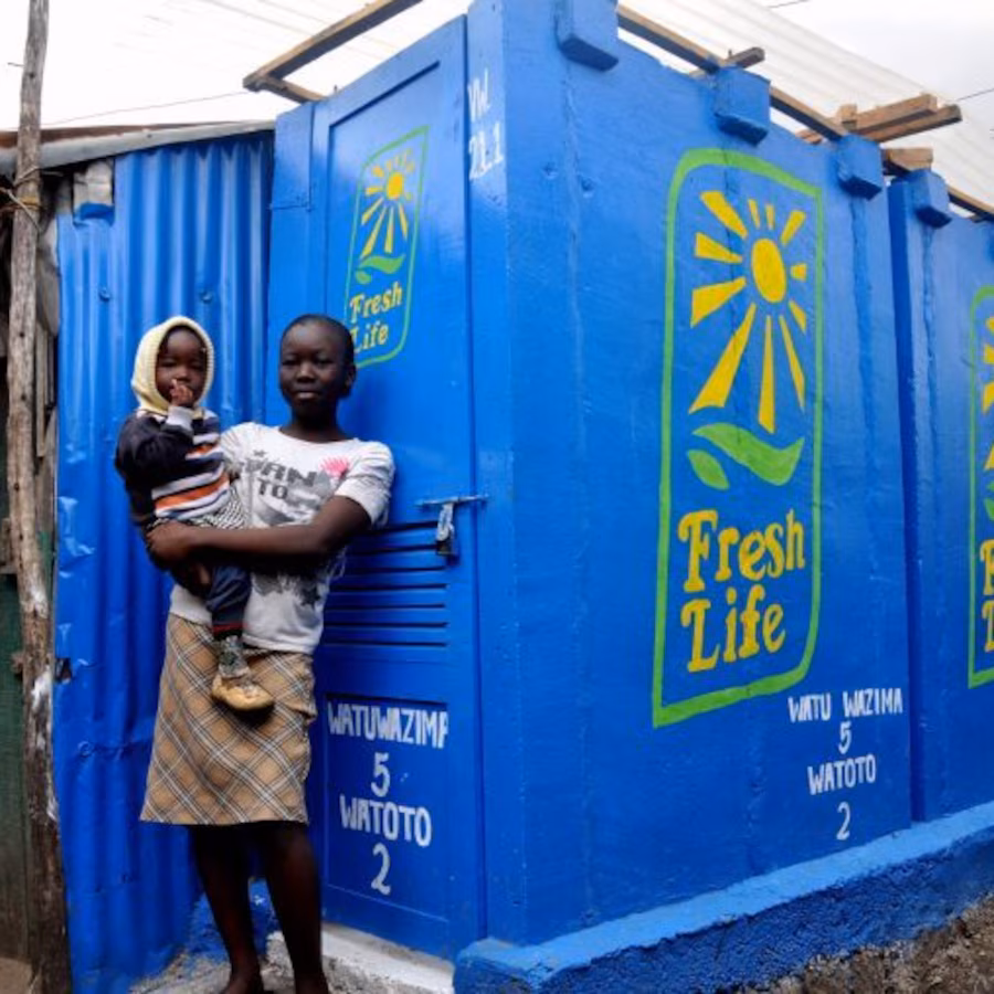 Mother and child outside FreshLife toilet