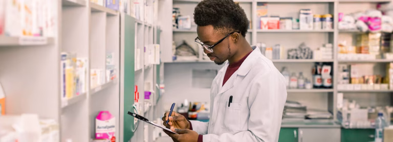 Young pharmacist with clipboard