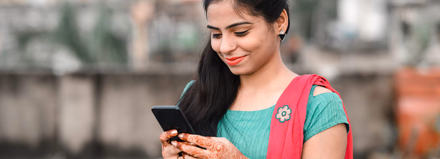 Young woman in saari smiling on phone