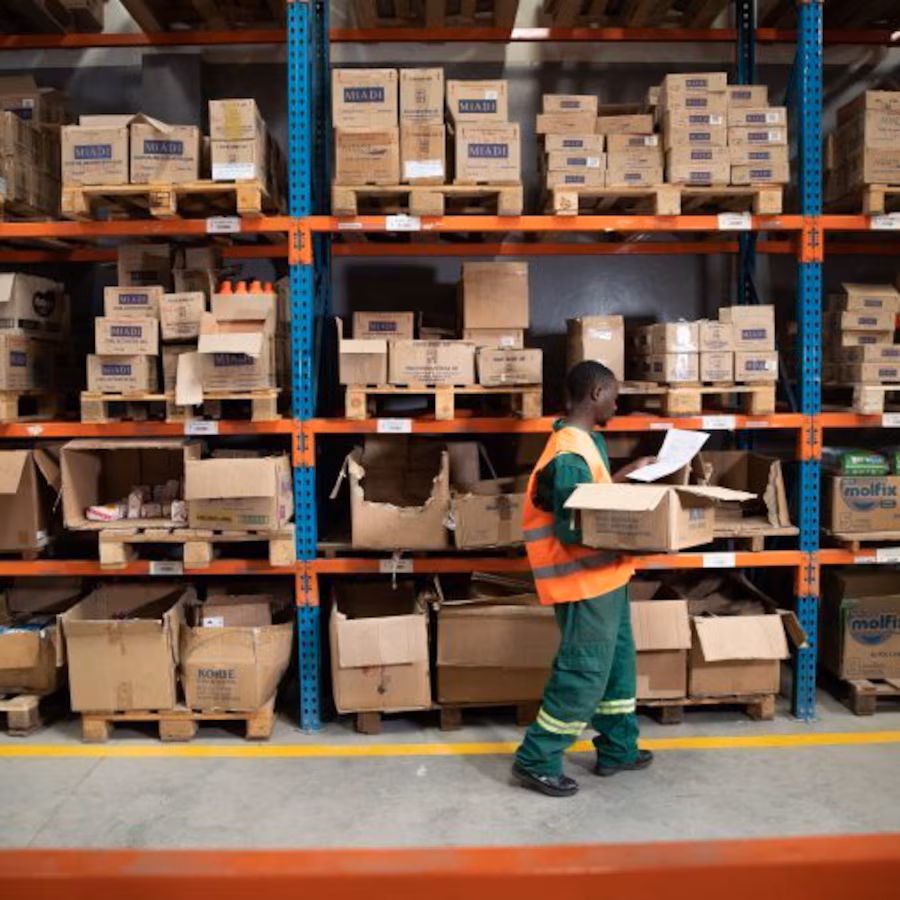 Man unpacking shelves in warehouse