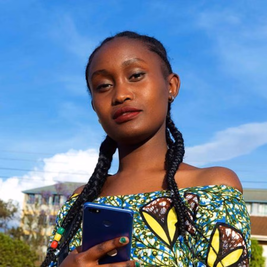 Young woman in fashionable dress poses for photo