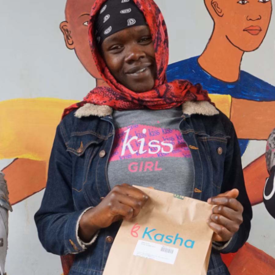 Woman with headscarf smiling holding bag