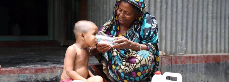 Young boy drinking water
