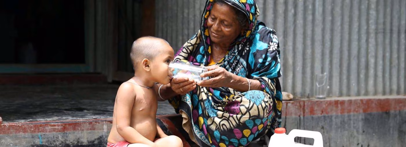 Young boy drinking water