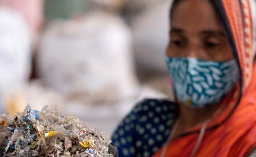 Woman in facemask clearing plastic