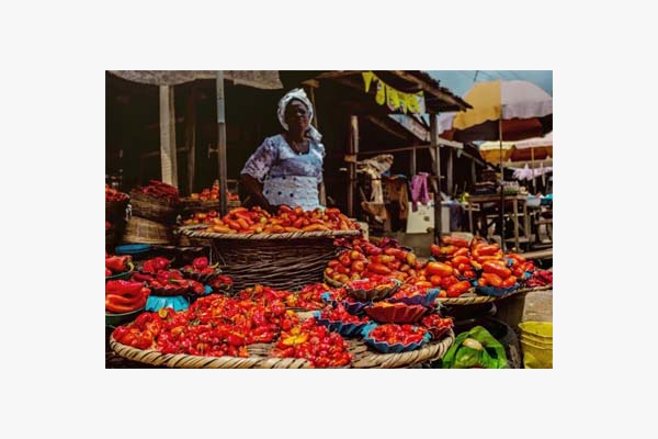 Woman stood by fruit and veg stall