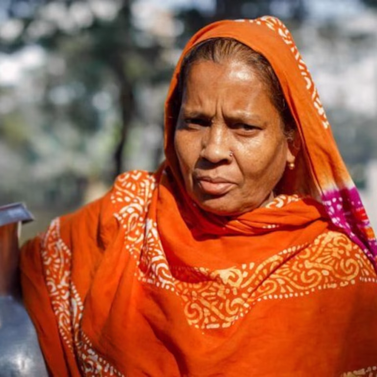 Woman carrying container of water
